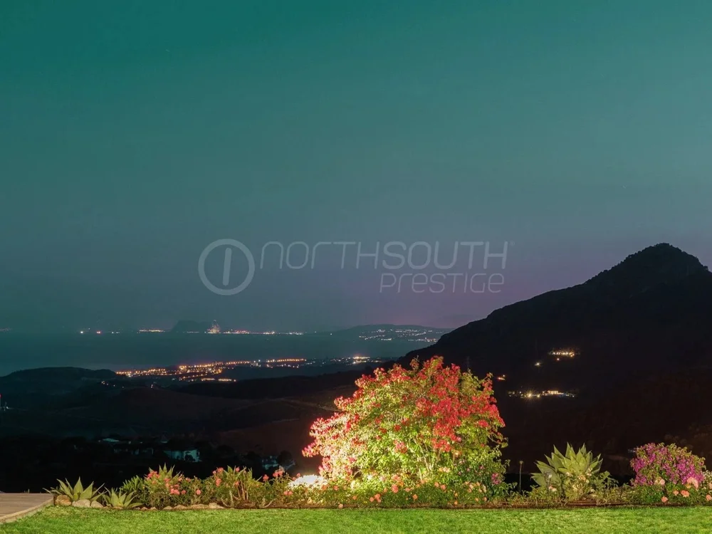 The lights of Marbella and the coast at twilight, seen from the hills above