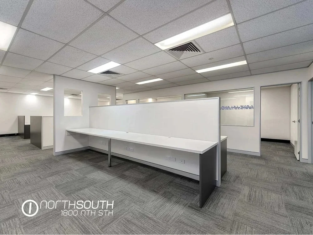 Image of brisbane commercial property for sale open-plan office level with built-in desks and data points.