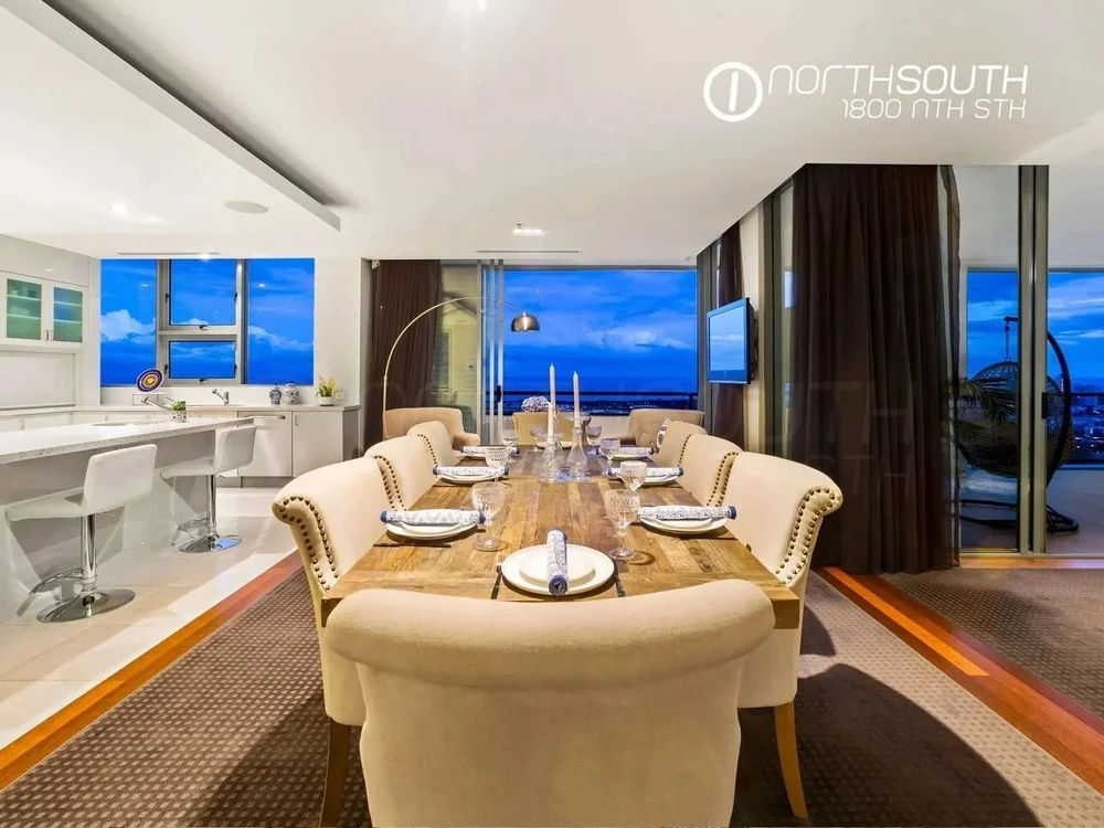 Image of properties for sale gold coast southport apartment penthouse dining room with skyline views.