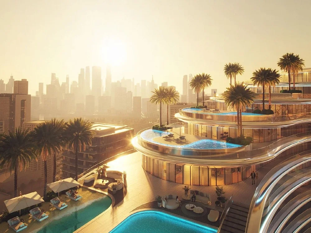 Sunset view of Binghatti Aquarise pool and illuminated façade, reflecting modern properties for sale Dubai luxury apartments.