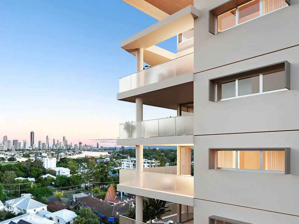 Modern multi-story apartment building with balconies, overlooking a city skyline with tall buildings, rivers, and green trees at sunset.