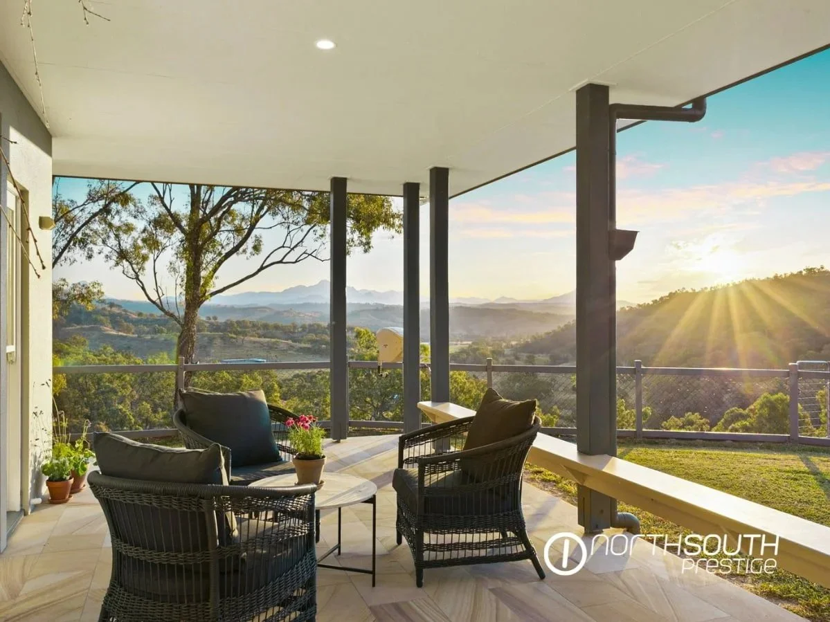 Front balcony at sunset overlooking sweeping mountain views, highlighting privacy and timeless off-grid living.