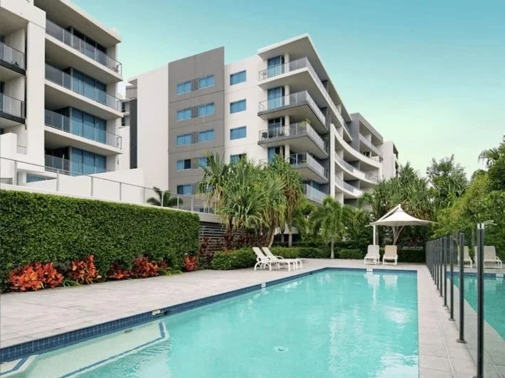 Large swimming pool and landscaped grounds in modern apartment complex at 2202 East Quay Drive Biggera Waters QLD.