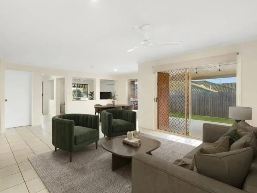 Open plan living area with tiled floors, sofa seating, indoor outdoor flow to backyard, sliding doors, ceiling fan and natural light.