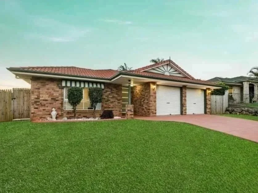 Front façade of 13 Turquoise Crescent Griffin showing brick exterior, double garage and established front lawn.