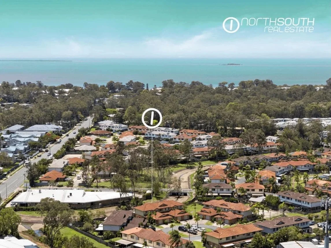 Aerial view of Thorneside townhouse complex with surrounding residential streets and bayside greenery