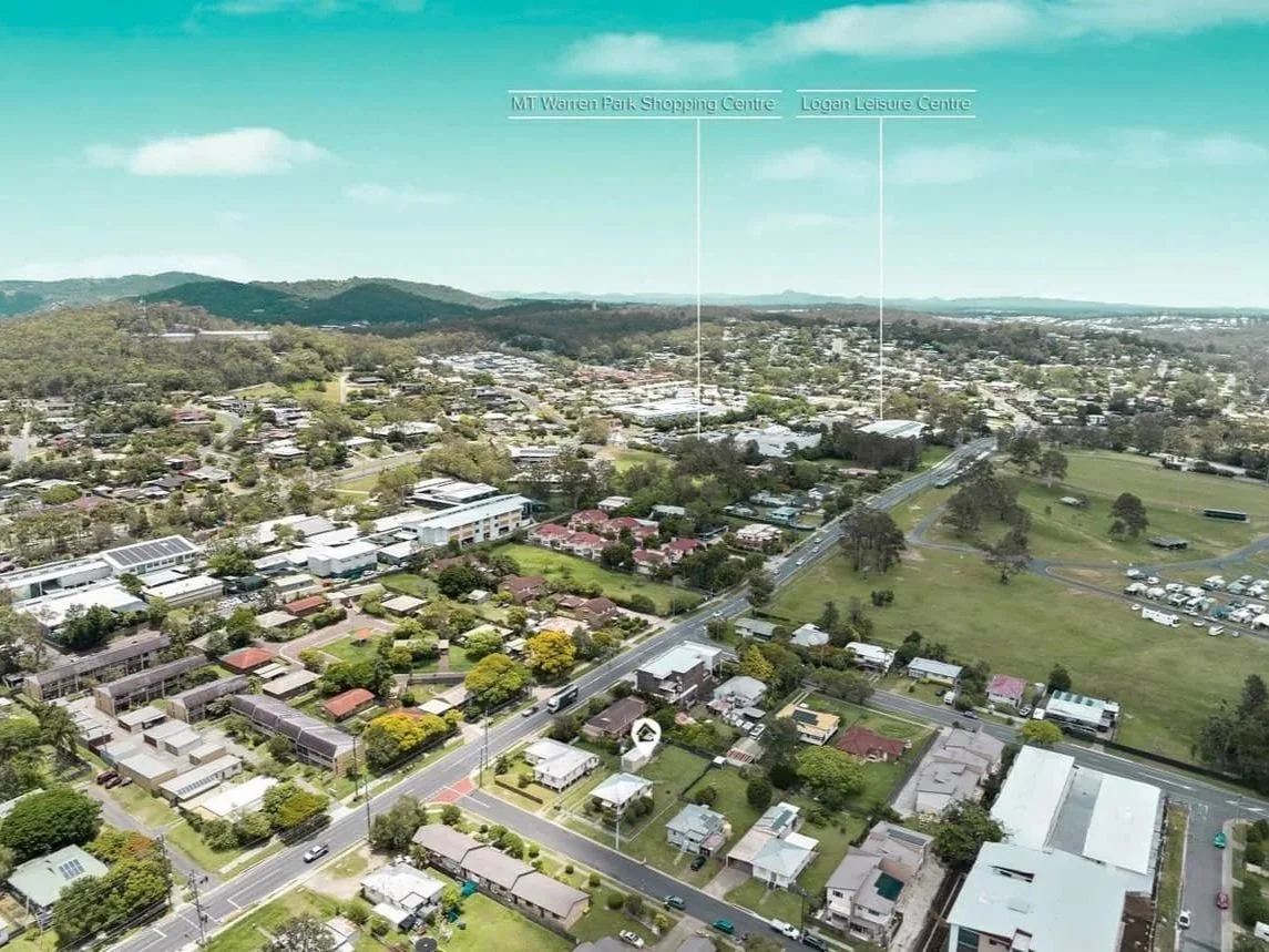 Wide aerial view of Beenleigh showing nearby shopping centres, leisure facilities and parkland, highlighting the lifestyle appeal of a future development site.