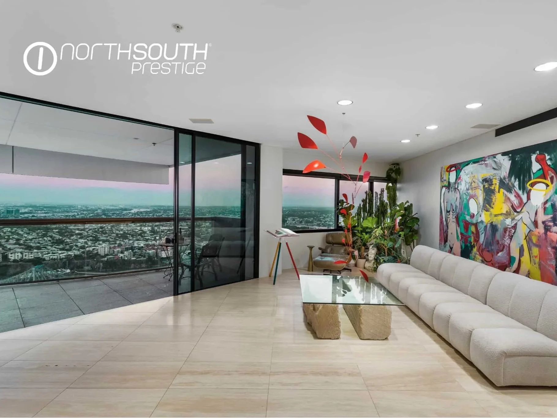 Entertainment area with artwork and city views from the balcony – Brisbane properties for sale Riparian Plaza apartment 5002 