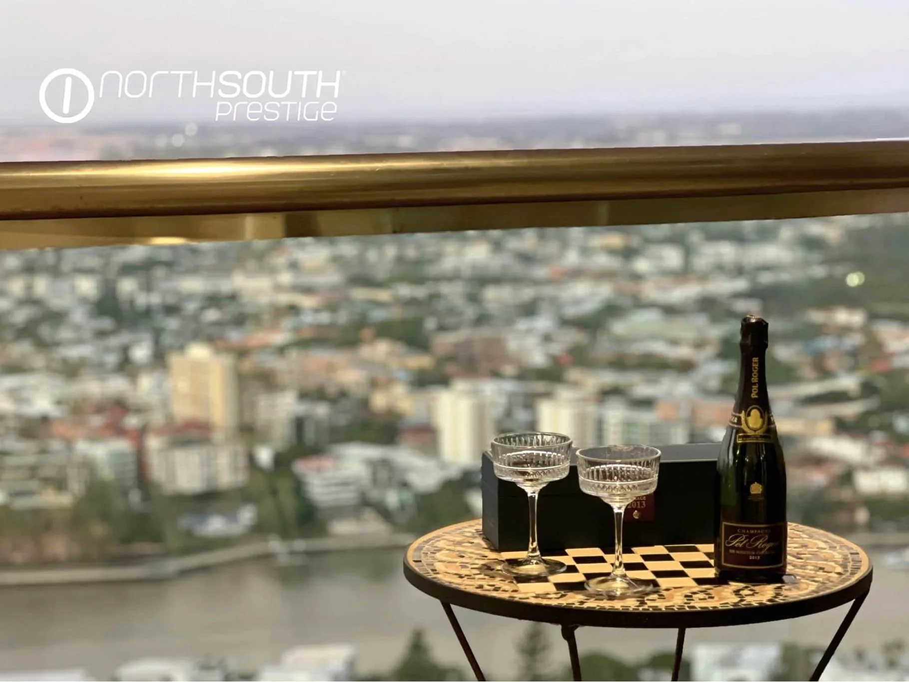 Pol Roger champage with glasses overlooking the city from the balcony – Brisbane properties for sale Riparian Plaza apartment 5002 