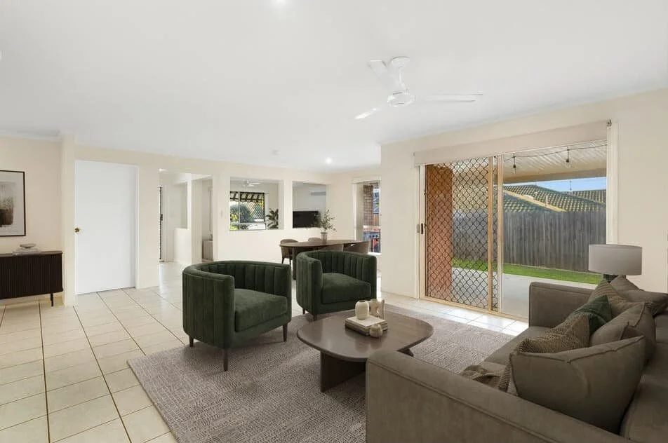 Open plan living area with tiled floors, sofa seating, indoor outdoor flow to backyard, sliding doors, ceiling fan and natural light.