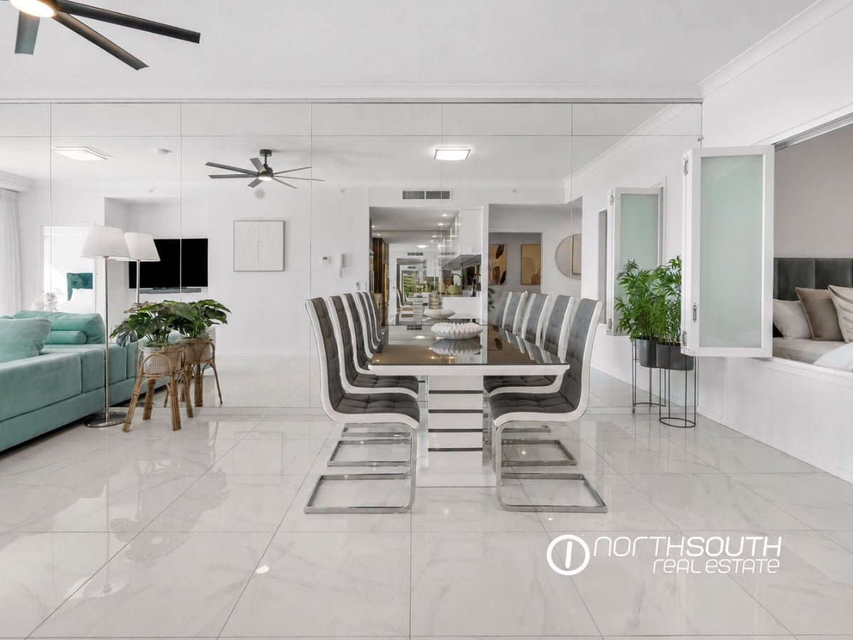 Dining area with mirrored walls at 3303/5 Harbourside Ct Waterpoint Residences, Biggera Waters QLD. 