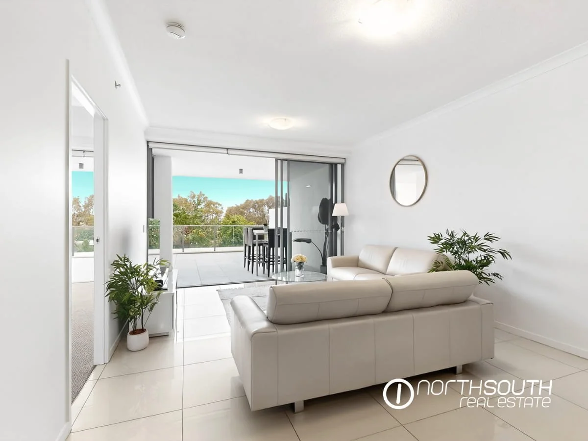 Living room with an oversized terrace overlooking a pool at 2202 25 East Quay Drive Biggera Waters