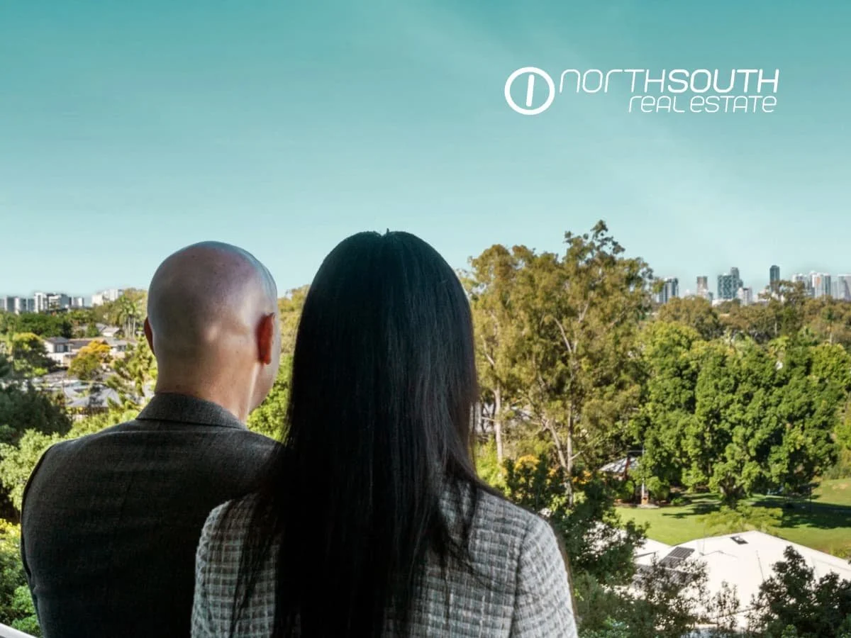 A couple looking at the Gold Goast city skyline views from level 4 of 3409 Waterpoint Residences, Biggera Waters QLD.