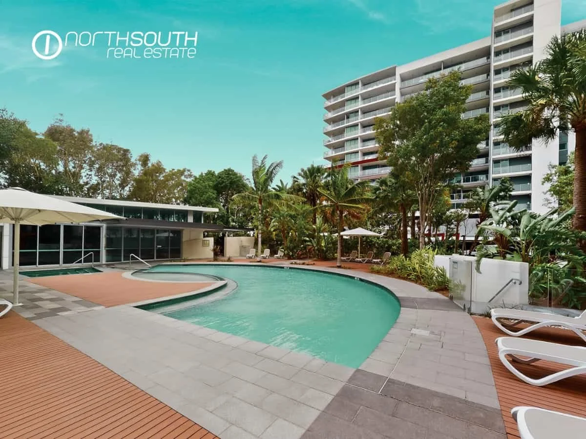 Large swimming pool and landscaped grounds in modern apartment complex at 2202 25 East Quay Drive Biggera Waters