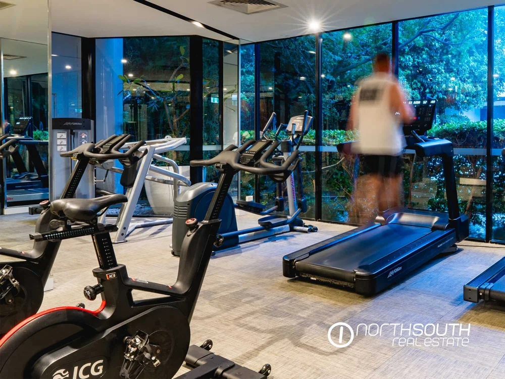 Spacious residents gym overlooking the water at WaterPoint highlighting lifestyle driven properties for sale in Biggera Waters