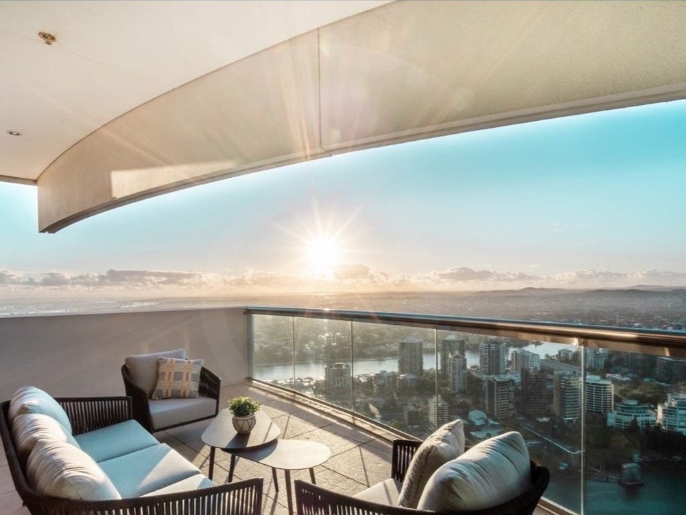 Sunset from Riparian Plaza verandah in Brisbane, symbolising building wealth through property with expert real estate advisory