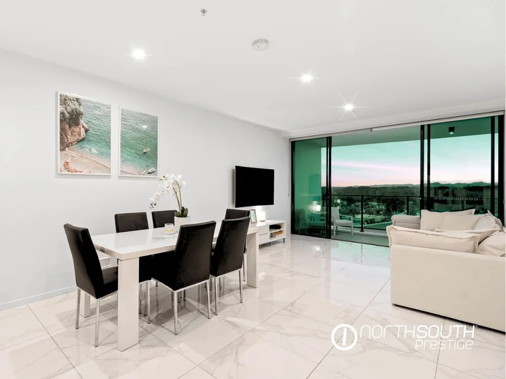 Spacious living and dining zone with tiled floors and balcony access at Waterpoint Residences, Biggera Waters QLD.