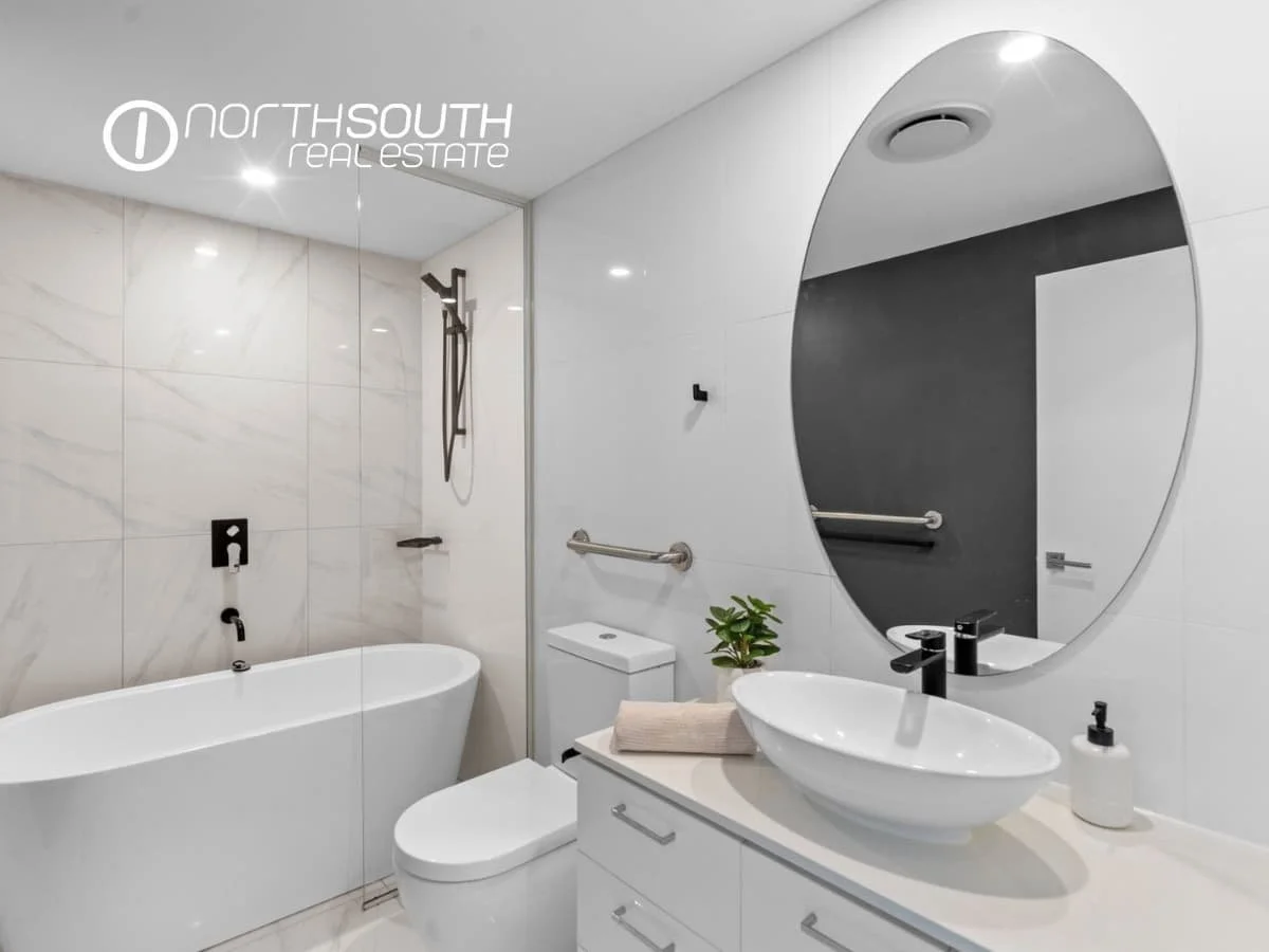 Guest bathroom with glass shower and tiled floors at 3409/5 Harbourside Ct Waterpoint Residences, Biggera Waters QLD.