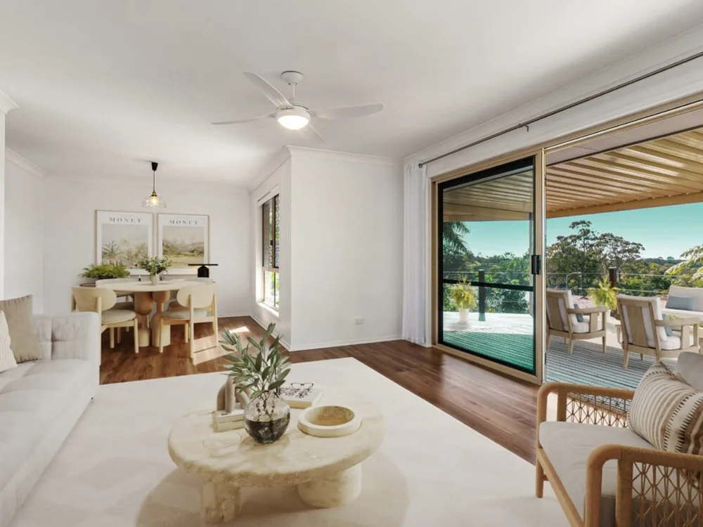 Open-plan living and dining area with sliding doors opening onto an outdoor deck in a home purchased through buyers advocacy. Parkwood, Gold Coast, Qld.