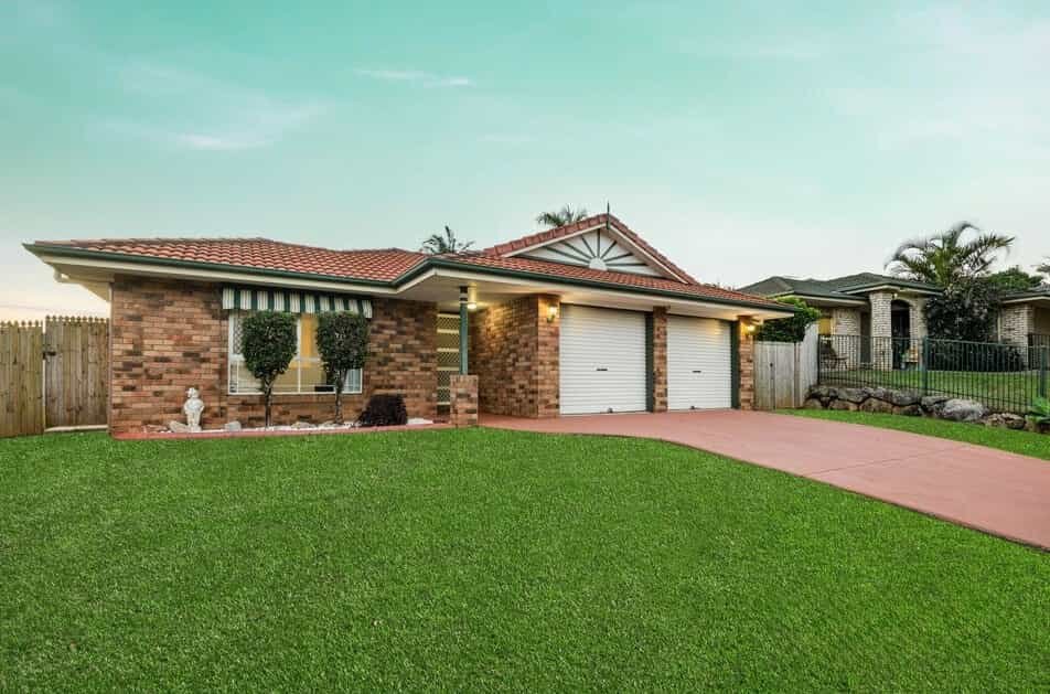 Front façade of 13 Turquoise Crescent Griffin showing brick exterior, double garage and established front lawn.