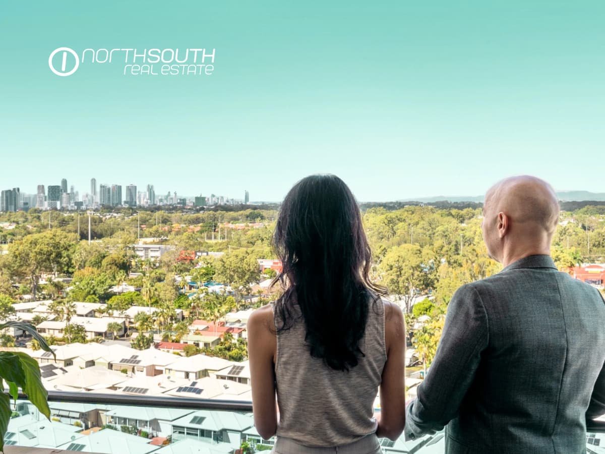 A couple looking at the Gold Coast Skyline views from level 11 of 51109 Waterpoint Residences, Biggera Waters QLD.