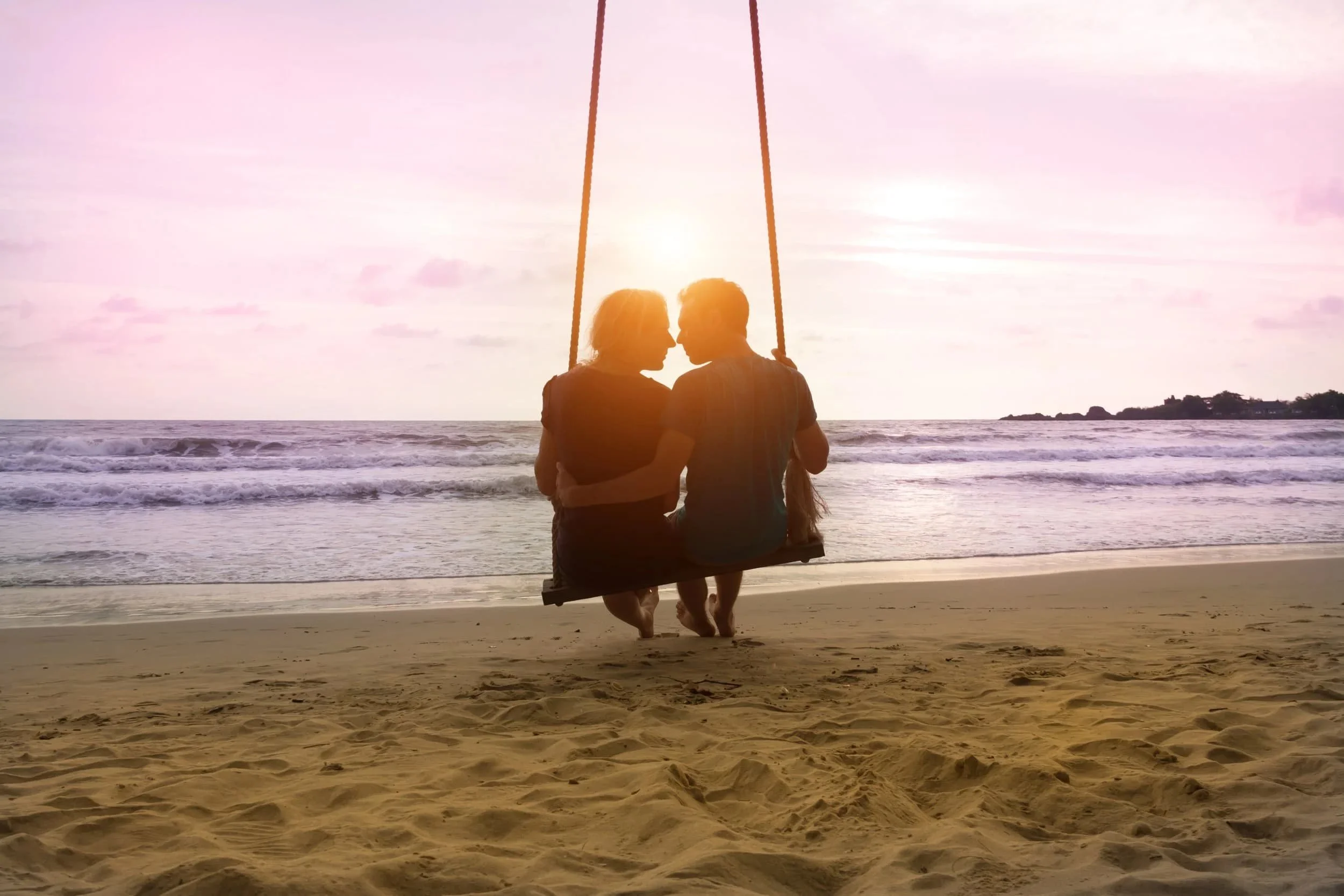 A couple enjoying quality time together on a swing