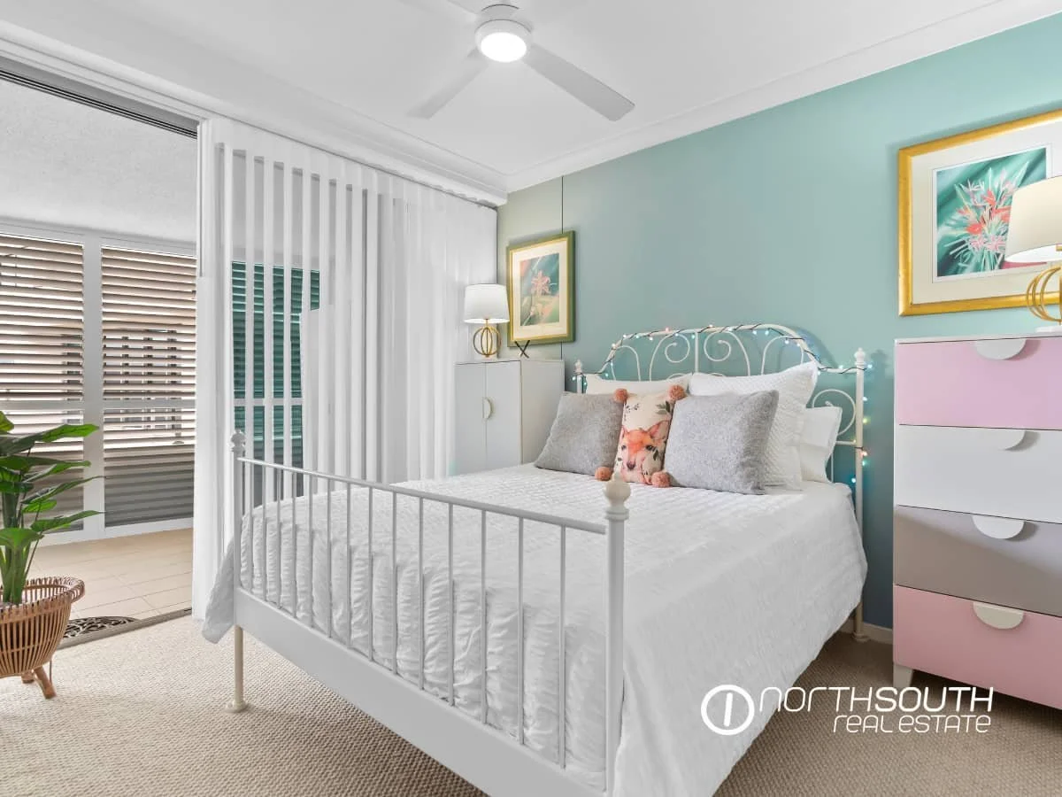 Master bedroom with curtains leading to the terrace at 301 41 Harbour Town Drive Biggera Waters