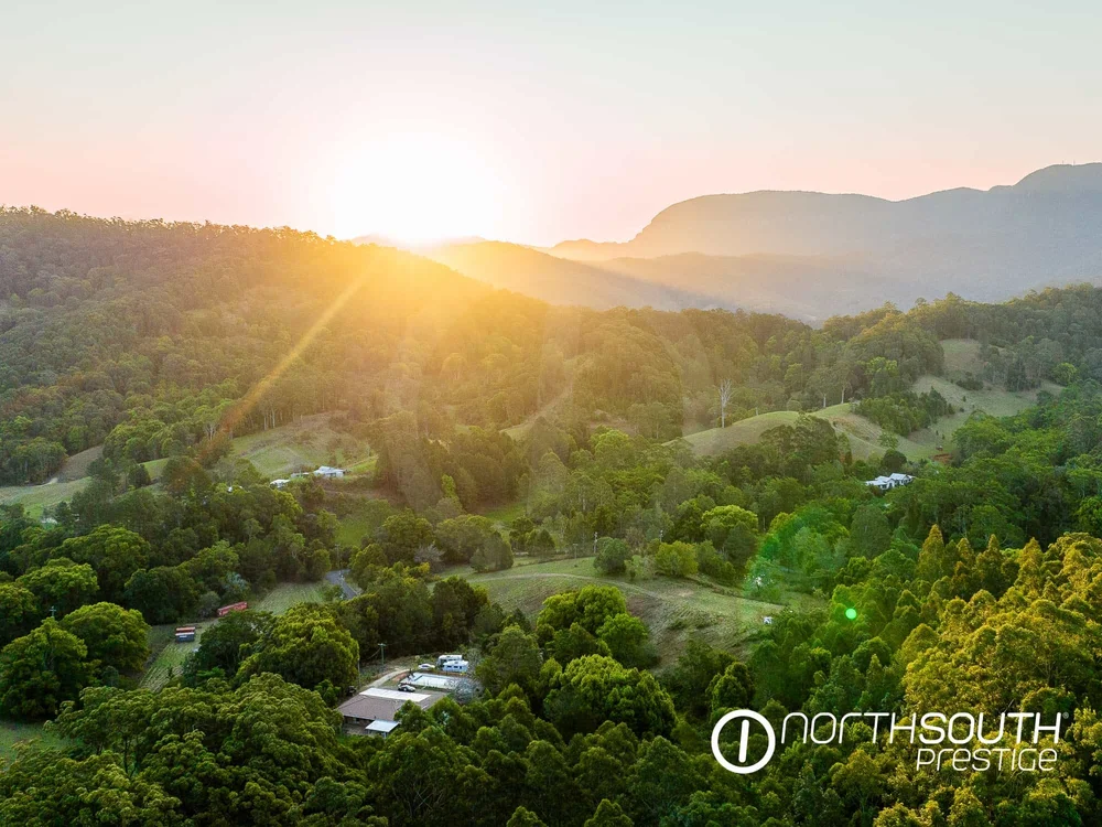 Sunset over the Rolling hills at properties for sale northern nsw nobbys creek 100 acres, offering stunning rural views.