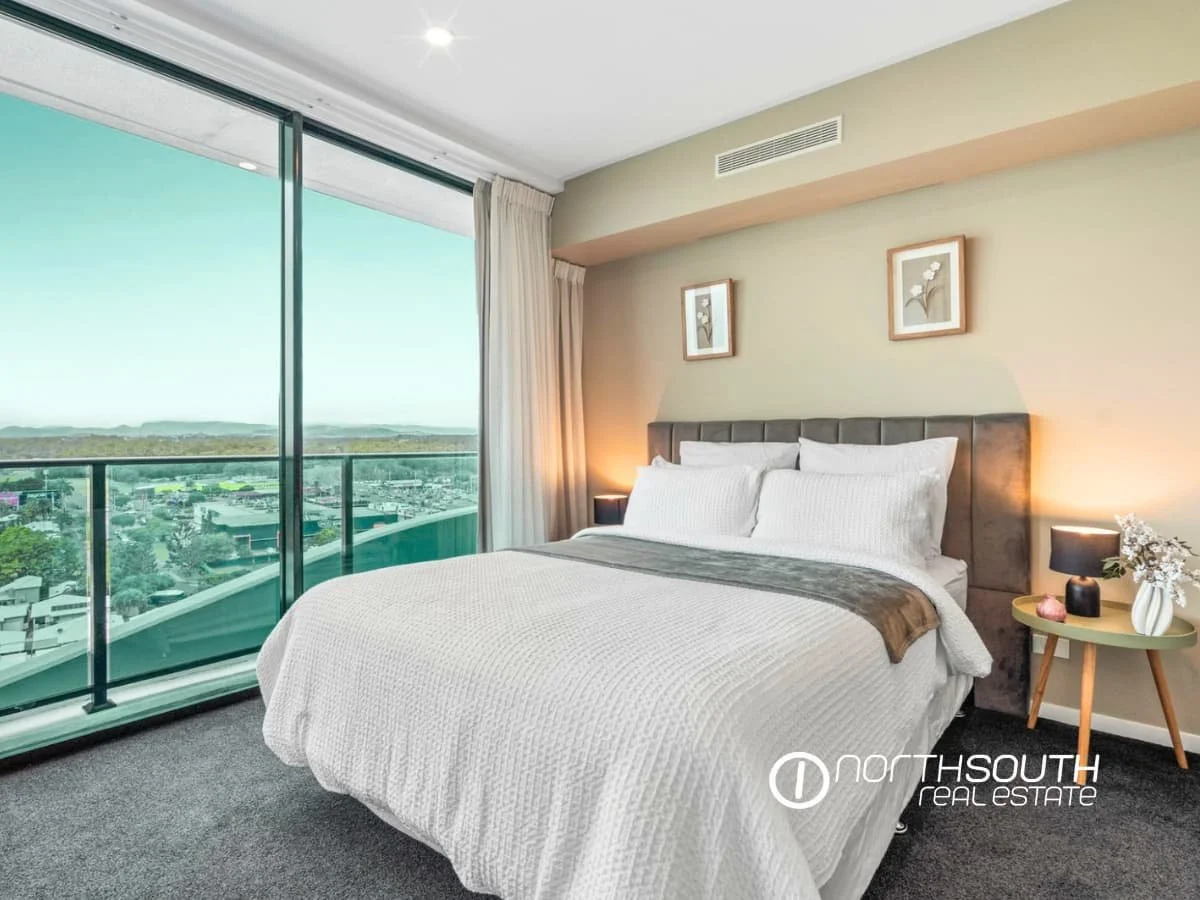 Spacious master bedroom with balcony and hinterland views at 51109 Waterpoint Residences, Biggera Waters QLD.