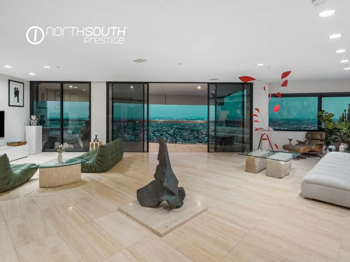 Living and Dining area with city views from balcony on twilight – Brisbane properties for sale Riparian Plaza apartment 5002 