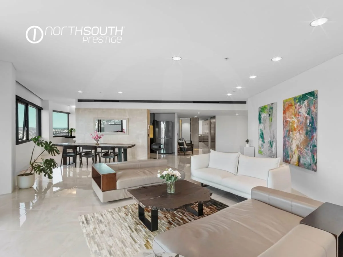 Living and Dining area with tiled floors and leather lounge furnishings and bright artwork - Brisbane properties for sale Riparian Plaza apartment 4903 