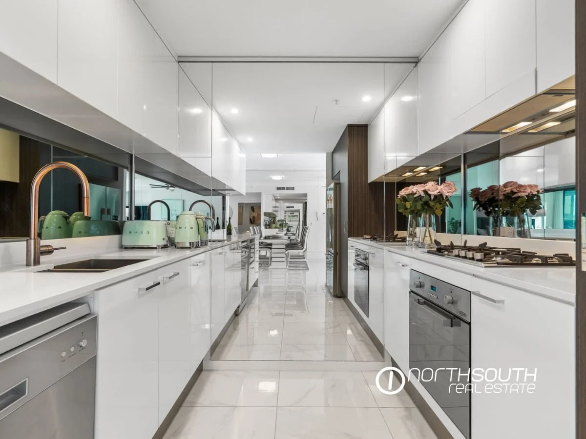 Kitchen with gas stovetop and appliances at  3303/5 Harbourside Ct Waterpoint Residences, Biggera Waters QLD.