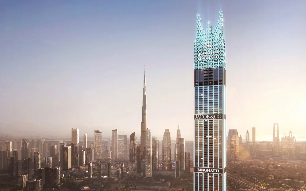 Futuristic skyscraper in Dubai with illuminated signage for Binghatti and Jacob & Co, city skyline and Burj Khalifa in the background during sunset.
