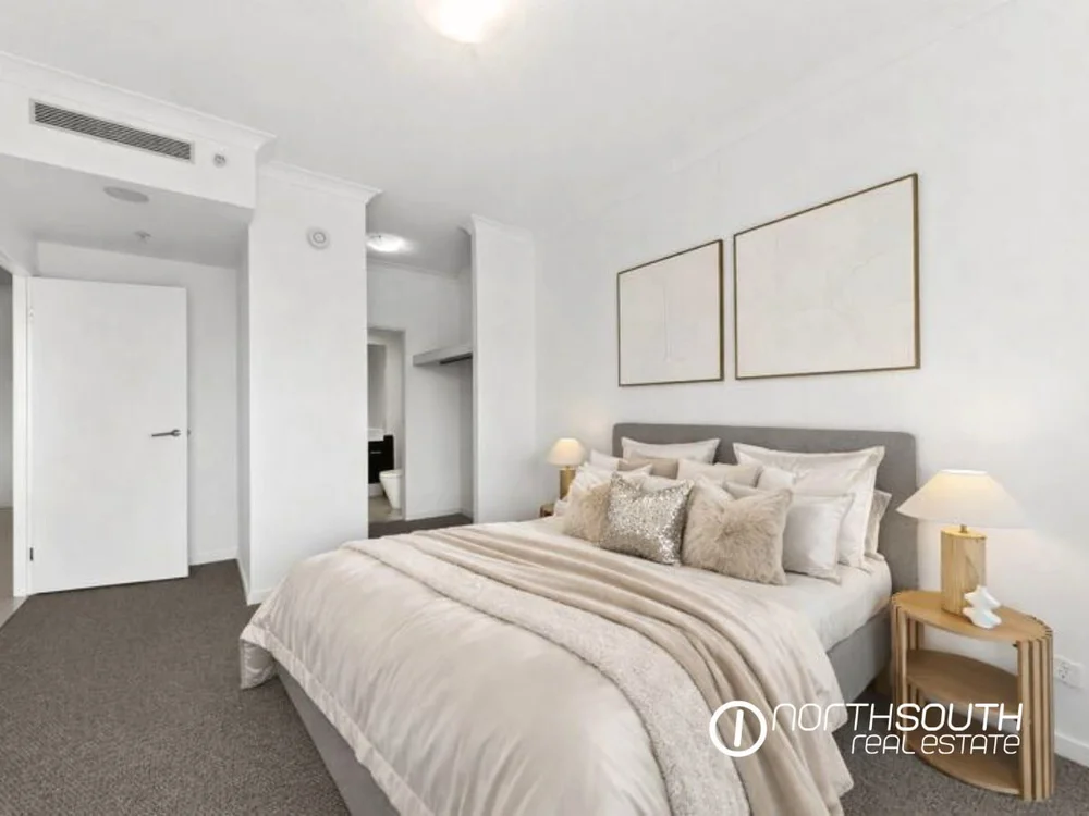 Master bedroom in pastel tones at fully furnished 2202 25 East Quay Drive Biggera Waters