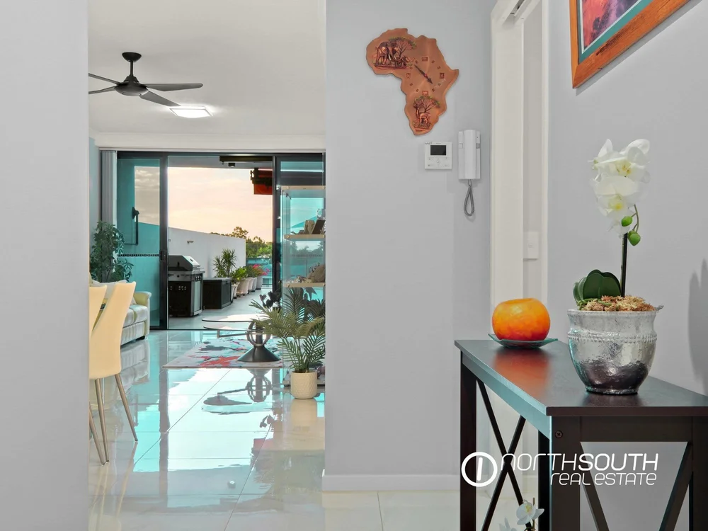 Hall leading to lounge and balcony view in properties for sale at Harbourside Biggera Waters