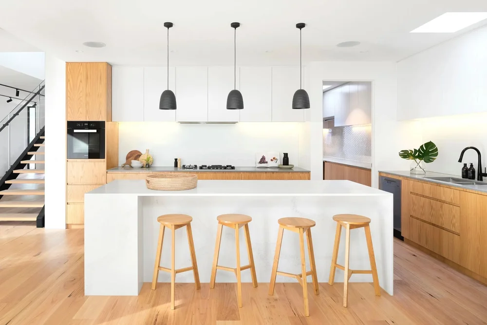 Modern Brisbane kitchen with timber and white design, highlighting residential investment appeal