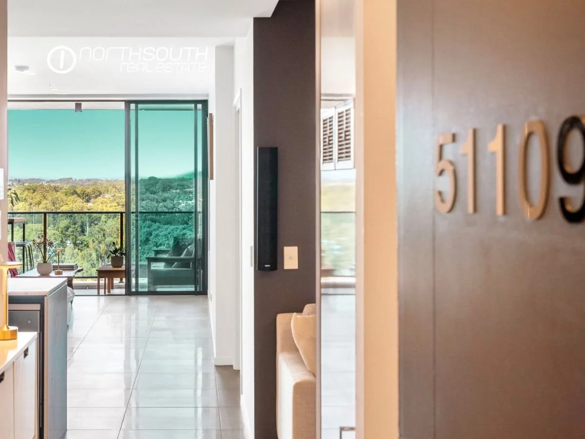 Entry to the apartment flowing into the living area and balcony of 51109 Waterpoint Residences, Biggera Waters QLD.