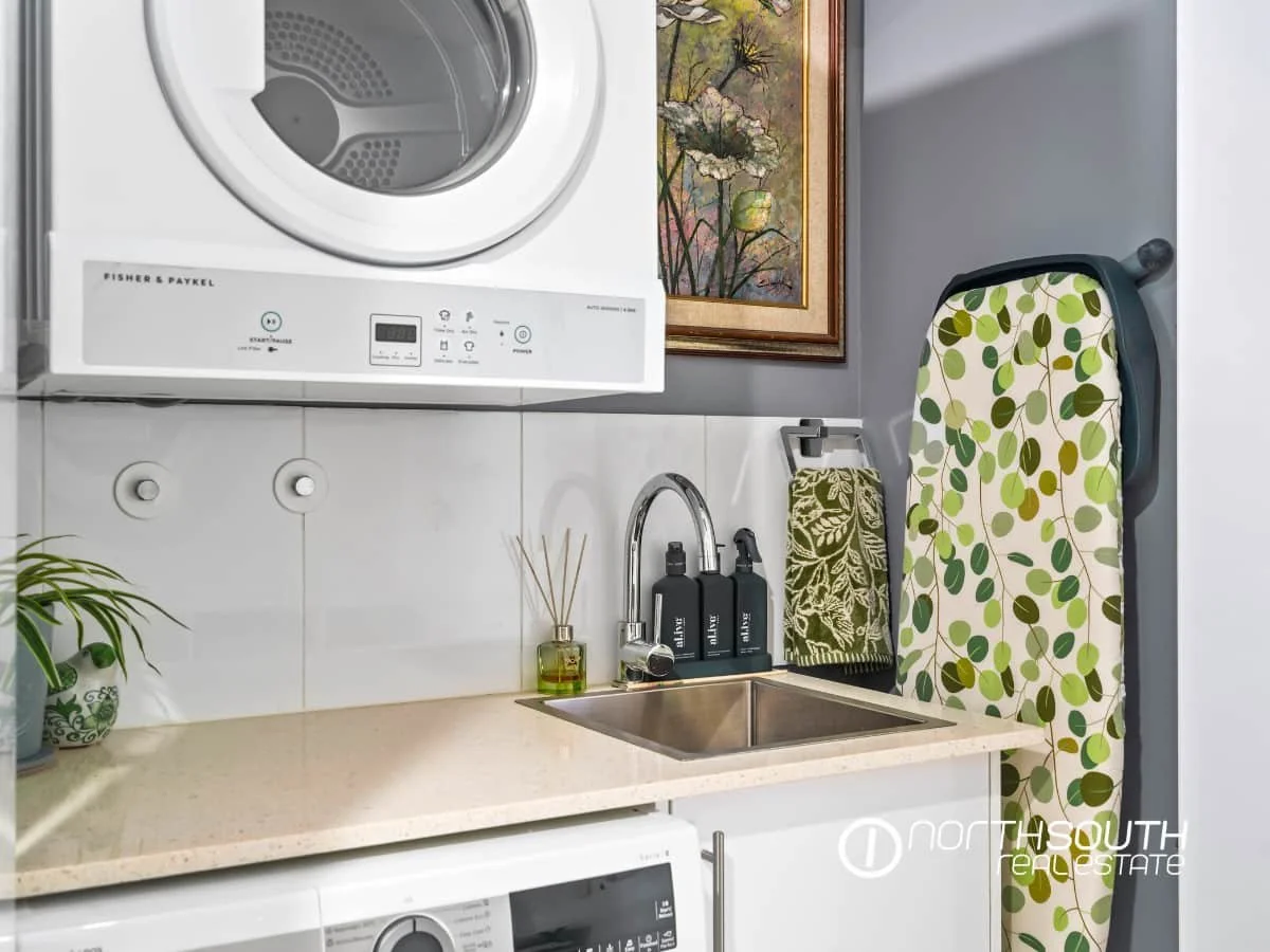 Upgraded laundry room with cabinetry at 301 41 Harbour Town Drive Biggera Waters
