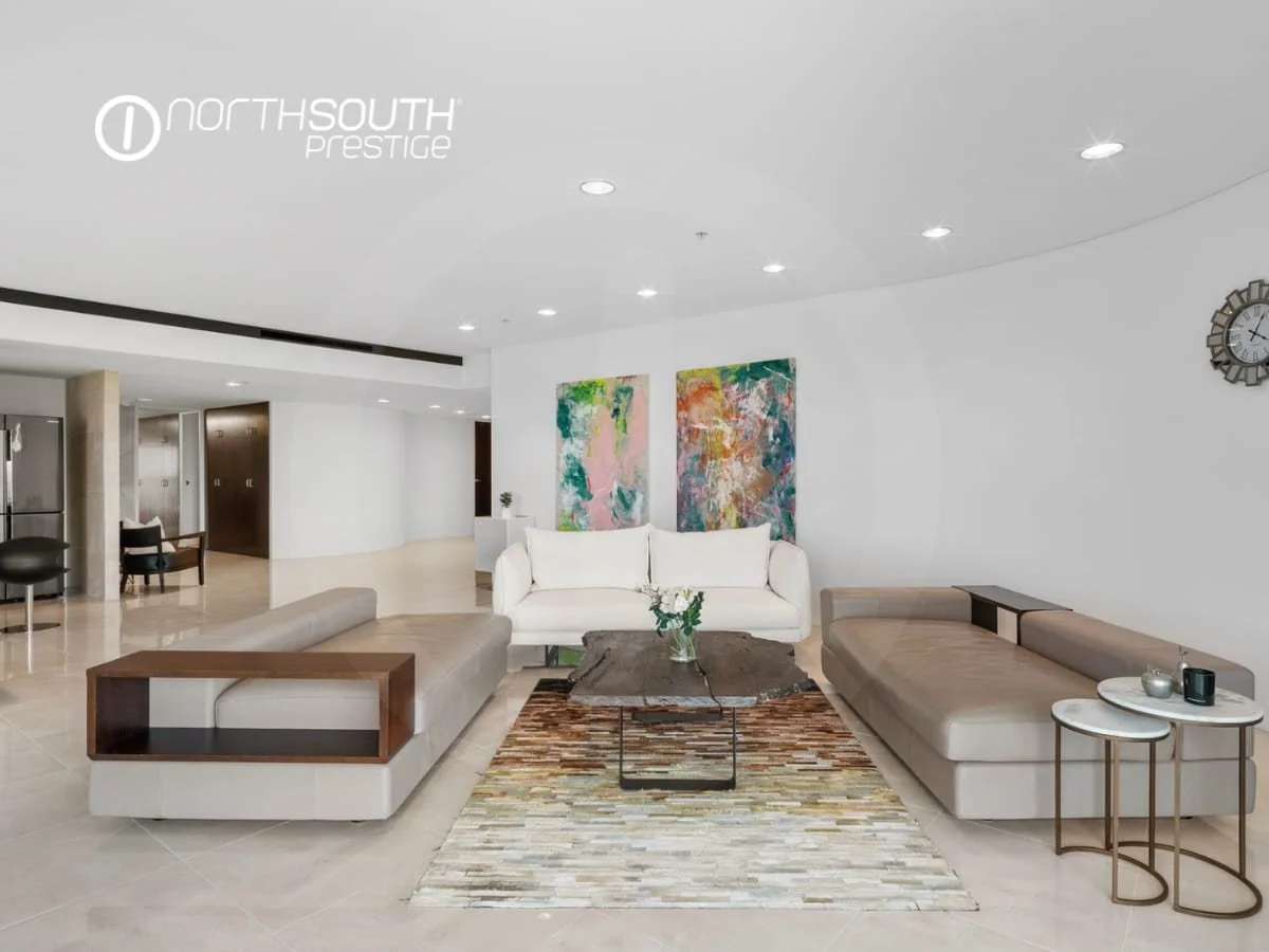 Living area with tiled floors and colourful art on the walls - Brisbane properties for sale Riparian Plaza apartment 4903 