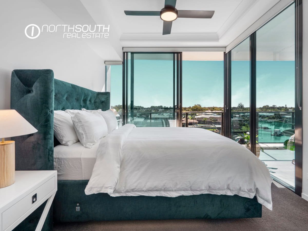 Spacious master bedroom with balcony overlooking water views at Waterpoint Residences 3303/5 Harbourside Ct , Biggera Waters QLD.