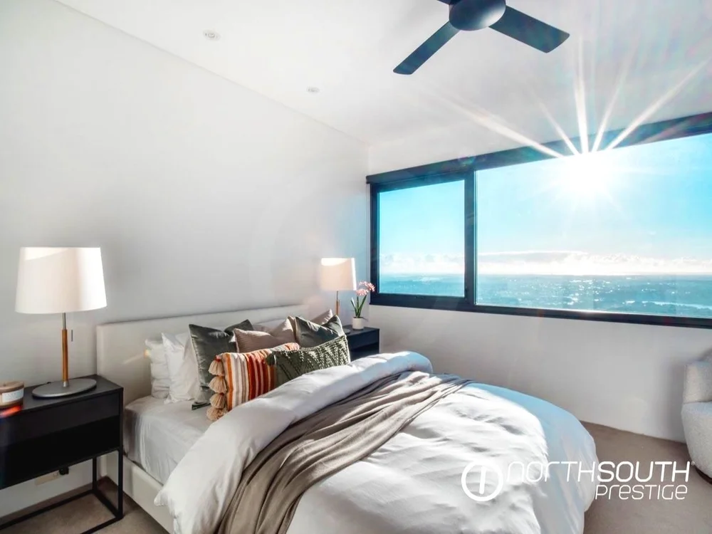 Sunlit bedroom in a luxury Brisbane apartment, representing ideal property for homebuyers