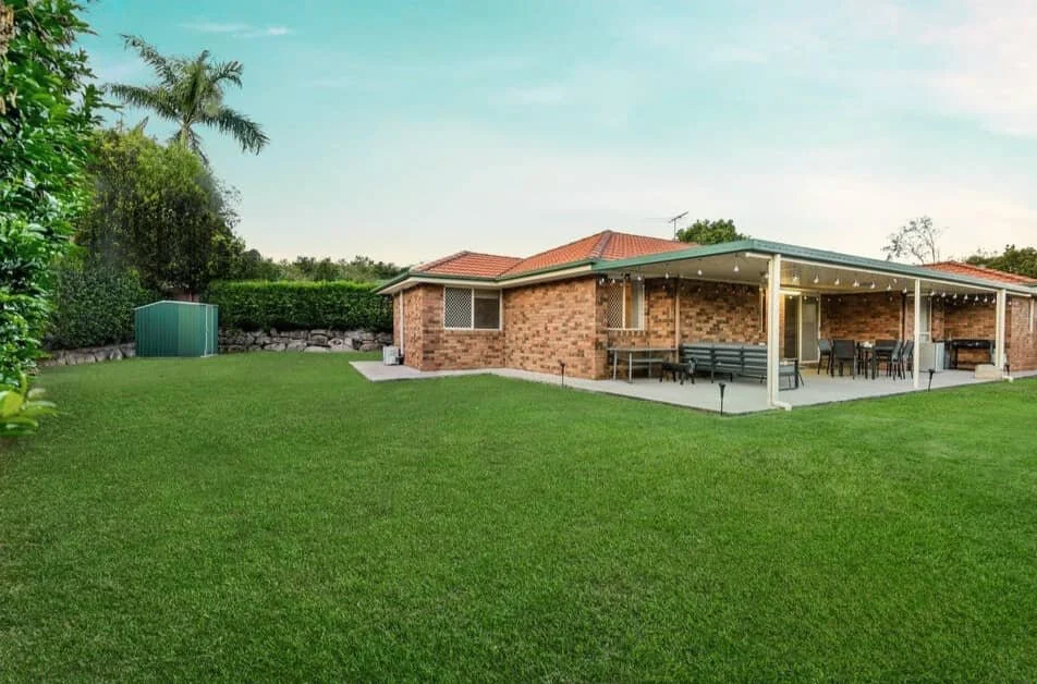 Spacious landscaped backyard at 13 Turquoise Crescent Griffin with level lawn, privacy hedging and garden shed secured through buyer advocacy.