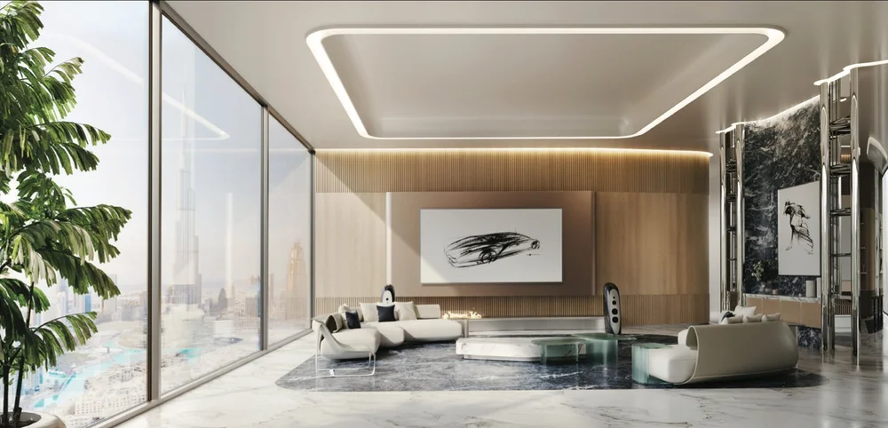 Modern living room with large windows, white curved sofas with black pillows, glass coffee table, abstract black and white artwork, and indoor plants.