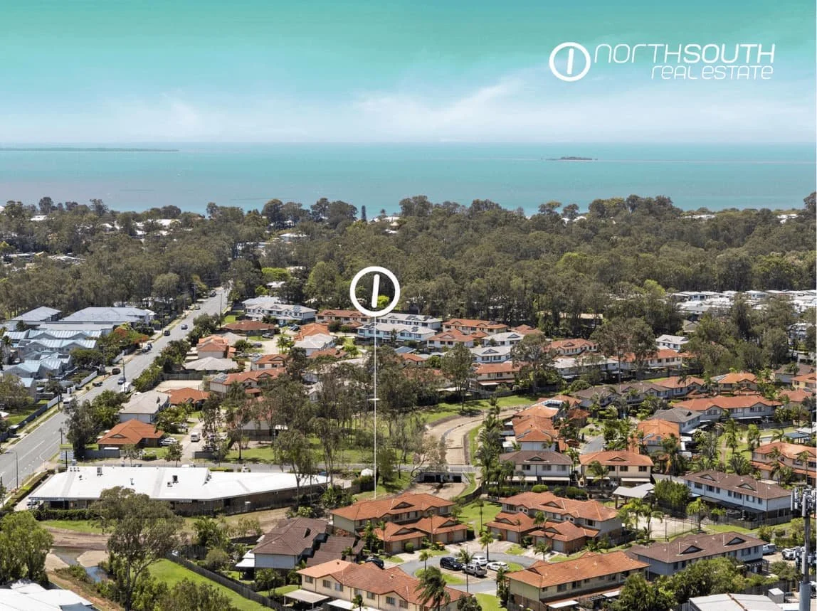 Aerial view of Thorneside townhouse complex with surrounding residential streets and bayside greenery