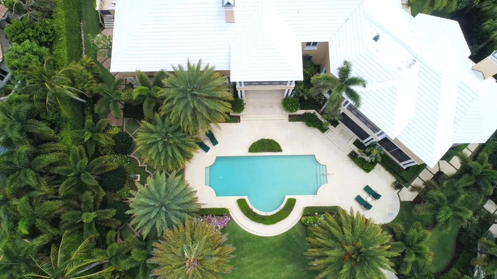 Aerial view of a luxury Queensland home with pool, ideal for buyers seeking prestige property
