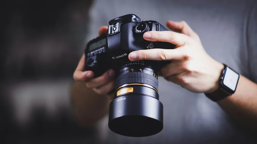 Professional photographer with high-end camera equipment for luxury property marketing services
