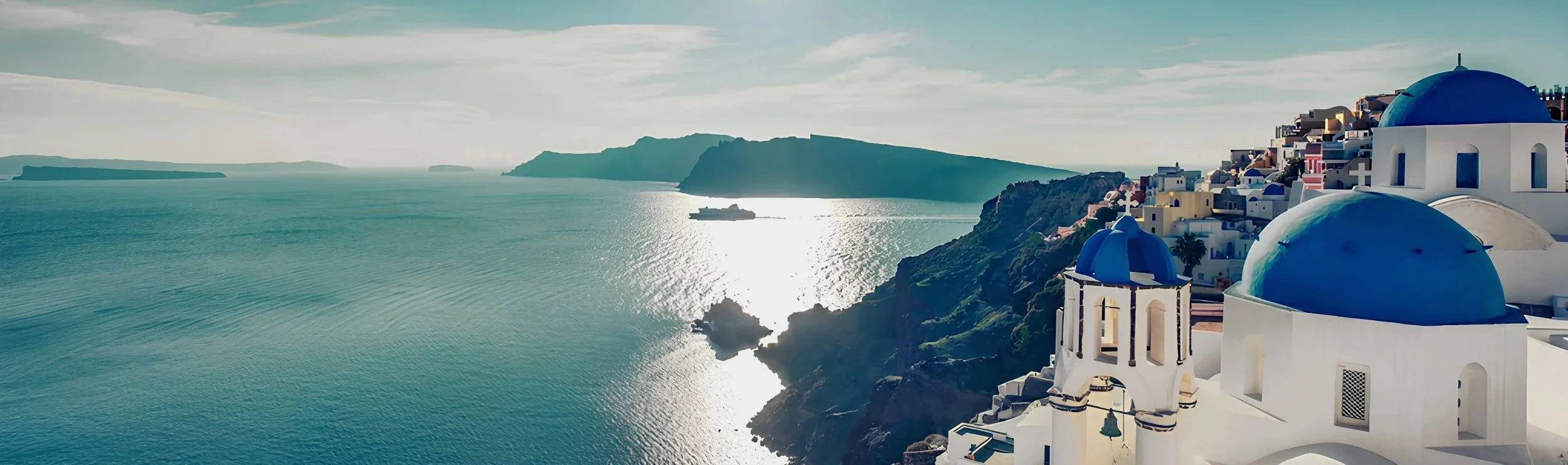 Whitewashed Santorini clifftop terrace overlooking the Aegean