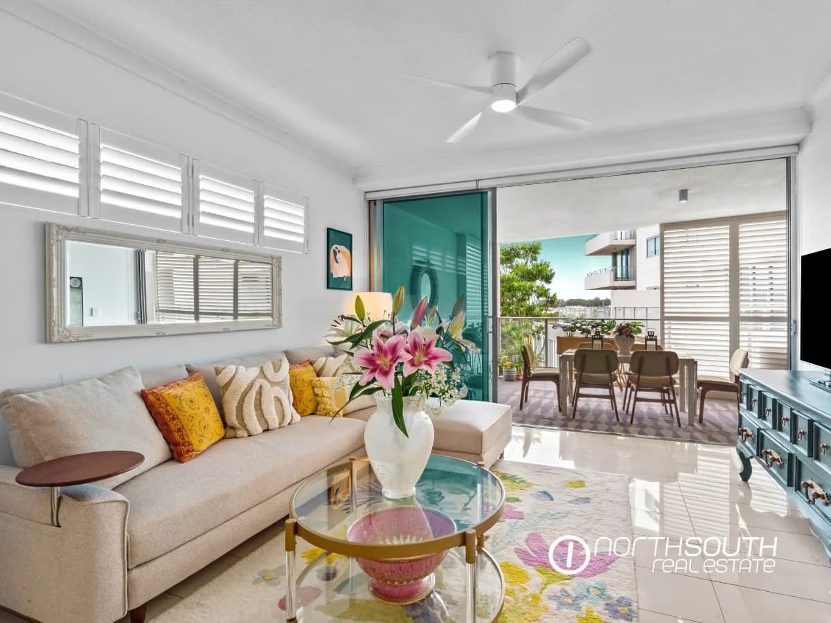 Living room lounge leading to large balcony at 301 41 Harbour Town Drive Biggera Waters