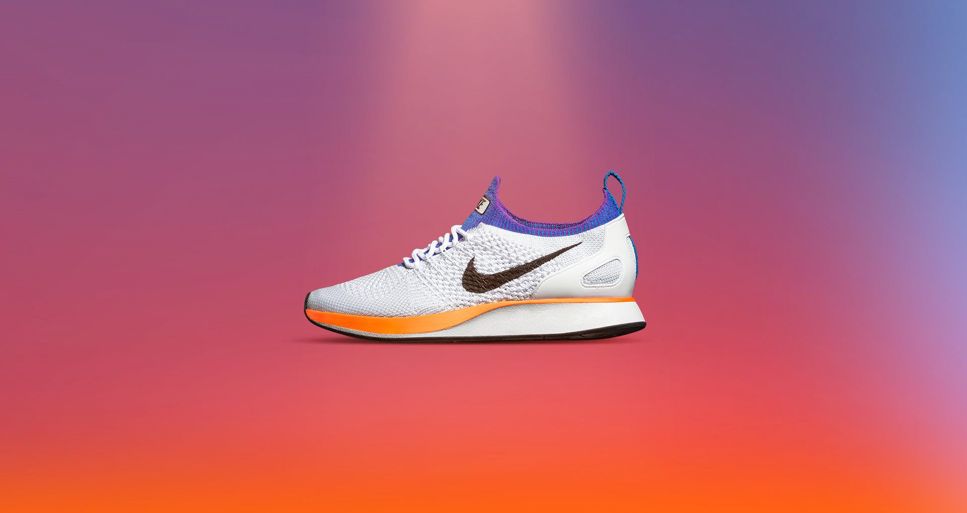 Colorful athletic shoe with Nike logo on a pink and purple gradient background.