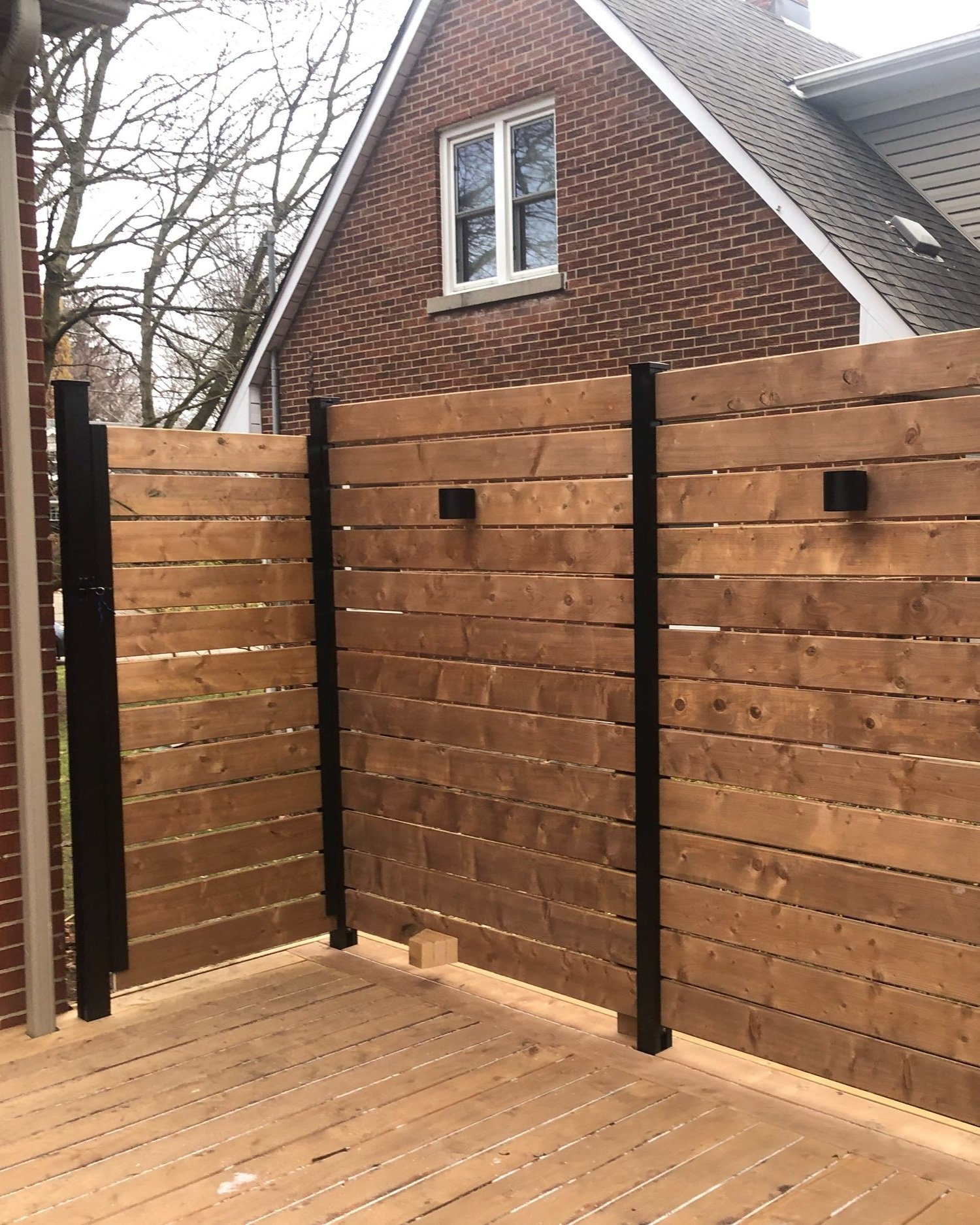 wood privacy fence with black hardware